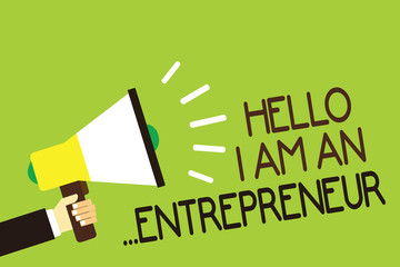 Conceptual hand writing showing Hello I Am An ...Entrepreneur. Business photo showcasing person who sets up a business or startups Man holding megaphone green background message speaking loud