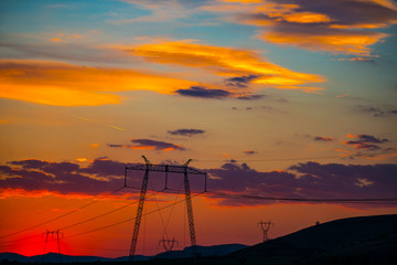 Fototapeta na wymiar Red sky and the electric pylons