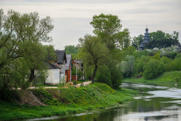 image of residential houses on the river bank in the town of Torzhok, Russia