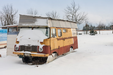 Old caravan covered  by snow in winter season