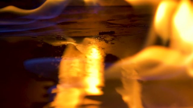 alcohol fire spreading across fluid on pan