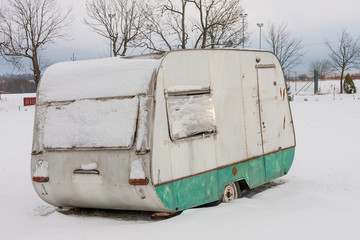 Camper covered by  snow in winter season in campsite