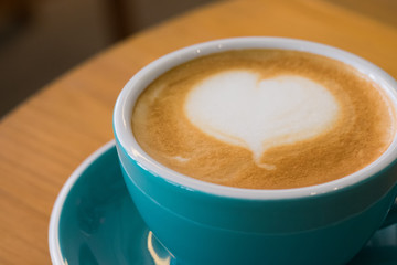 Cappuccino in a cup on the table in a coffee shop