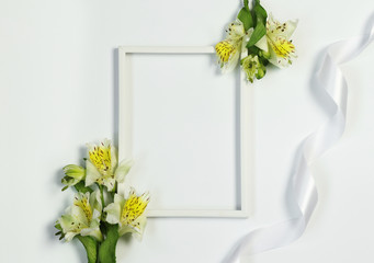 Mockup photo frame with flowers and ribbon on white background