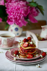 Pancakes with acacia flowers and strawberry chia sauce