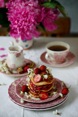 Pancakes with acacia flowers and strawberry chia sauce