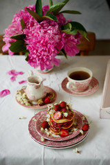 Pancakes with acacia flowers and strawberry chia sauce
