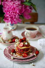 Pancakes with acacia flowers and strawberry chia sauce