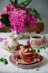 Pancakes with acacia flowers and strawberry chia sauce