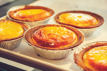 Several egg tart desserts on display