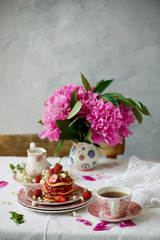 Obraz na płótnie Canvas Pancakes with acacia flowers and strawberry chia sauce