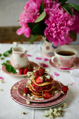 Pancakes with acacia flowers and strawberry chia sauce