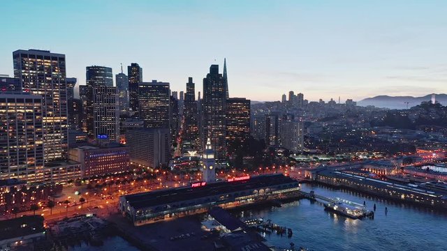 Aerial drone flythrough of the San Francisco city skyline and Ferry Building at night
