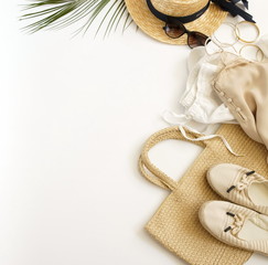 top view, flat lay fashion women summer travel clothes and accessory collage background. Straw hat, shoes, sunglasses , bag and palm leaf. Copy space