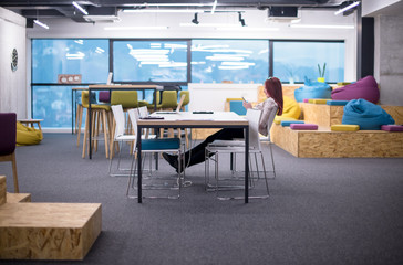 redhead businesswoman using mobile phone at office