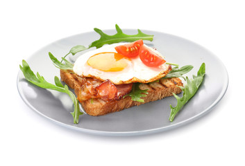 Plate with grilled bread, fried egg and bacon on white background