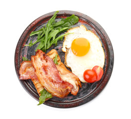 Plate with fried egg, bacon and tomato on white background