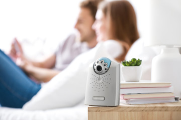 Modern baby monitor on table in parents' room