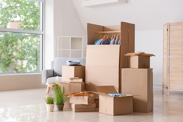Wardrobe boxes with clothes and other things in room