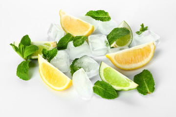 Ice cubes, fresh cut citrus fruits and mint leaves on white background