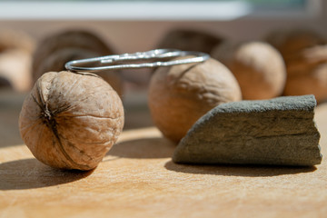 Two walnuts on top of them clip paper in the foreground stone