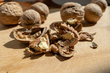 Whole walnuts in the background and foreground chopped nuts