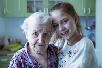 Portrait of an elderly woman with her beloved granddaughter.