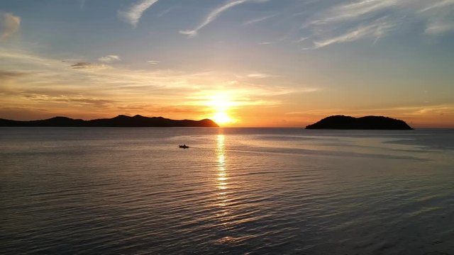 A beautiful sunset with a small boat in the bay, somewhere in Palawan, Philippines