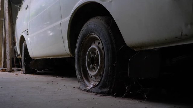 Old white Van With Flat Tires In A Barn in french counstryside in slowmotion