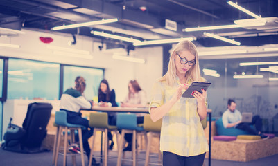 blonde businesswoman working online using digital tablet