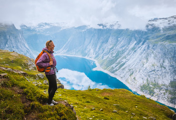 Naklejka na ściany i meble Norway hike. Sporty woman on top of rock near Trolltunga