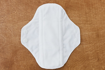 Reusable eco natural pad for menstrual days, flat lay. White feminine washable, healthy and eco...
