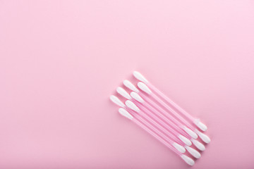Cotton buds over a pink background. Hygienic supplies.