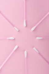 Cotton buds over a pink background. Hygienic supplies.