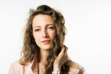pretty girl with long curly hair in a pink jacket on a white background