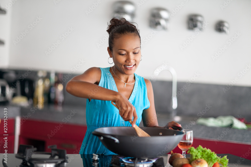 Wall mural Beautiful Asian woman preparing food