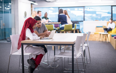 black muslim business woman having a meeting with her indian male colleague