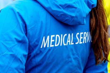 Medical service sign on the back of a female rescue service jacket