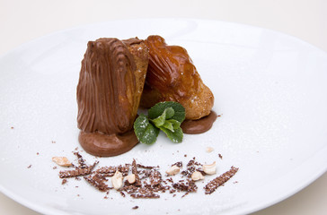 chocolate eclair cake on a white plate, restaurant table setting