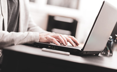 Hands of businessman using laptop