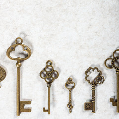 Decorative keys of different sizes and styles on grey background