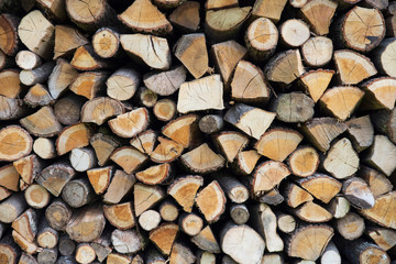 Background of stacked logs stored for fire making
