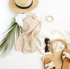 top view, flat lay fashion women summer travel clothes and accessory collage background. Straw hat, shoes, sunglasses , bag and palm leaf. Copy space