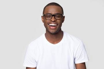 Headshot portrait african man in glasses laughing looking at camera