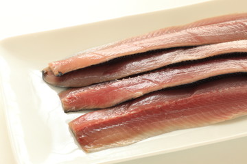Pacific saury prepared on dish for cooking image