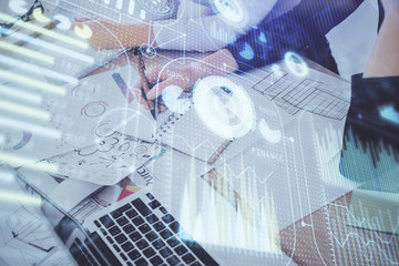 Double exposure of woman's writing hand on background with data technology hud. Big data concept.