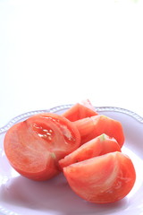 Cut tomato on dish with copy space