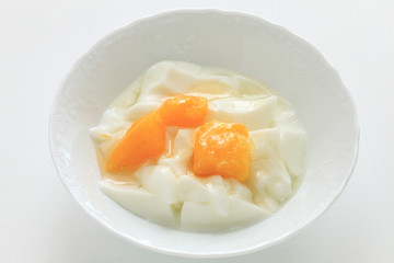Peach and yogurt on bowl