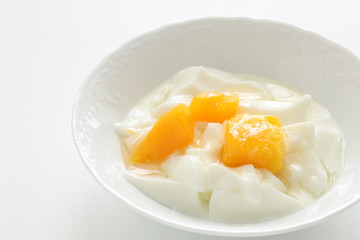 Peach and yogurt on bowl
