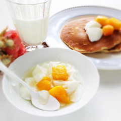 Peach and yogurt on bowl